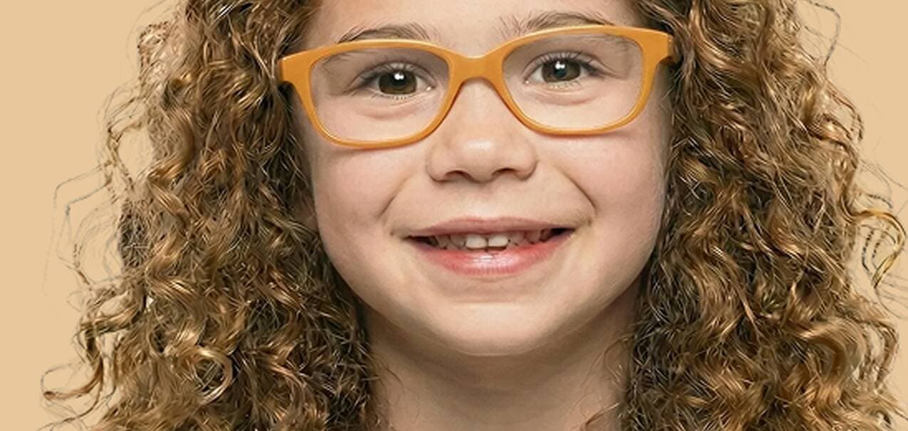 Child with glasses smiling
